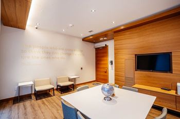 a conference room with a quote on the wall and a table