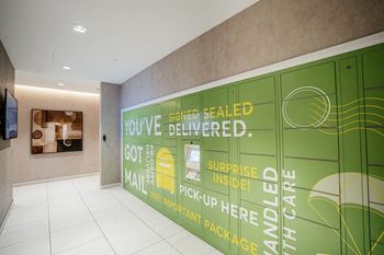 a wall of green lockers in a lobby of a building