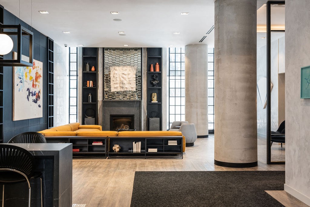 a living room with a fireplace and a yellow couch