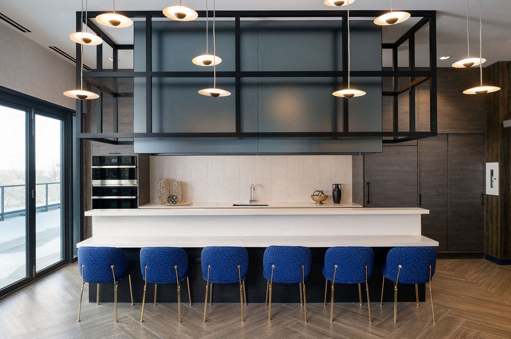 a kitchen with blue chairs and a white counter