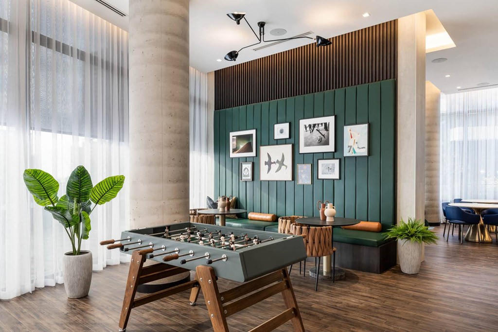 a foosball table in a room with a green wall