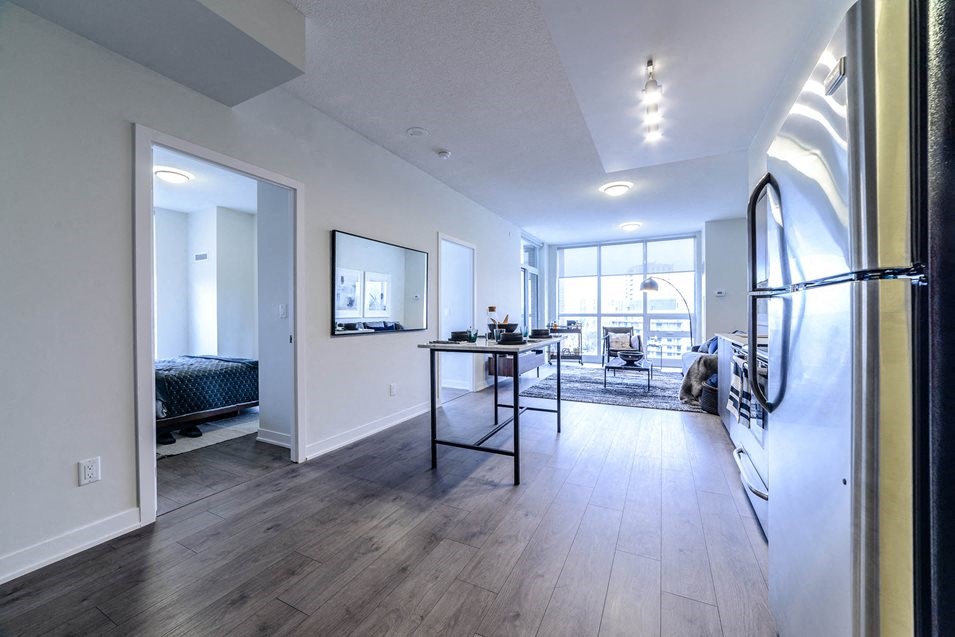 a view of a living room and a dining room from a hallway