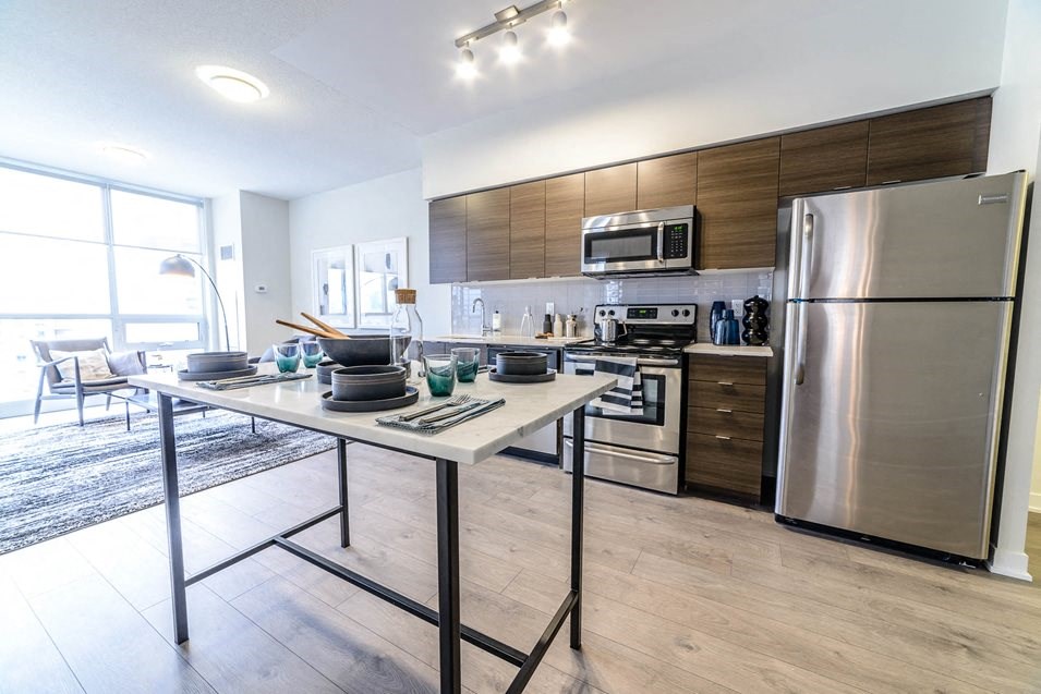 a kitchen with stainless steel appliances and a table