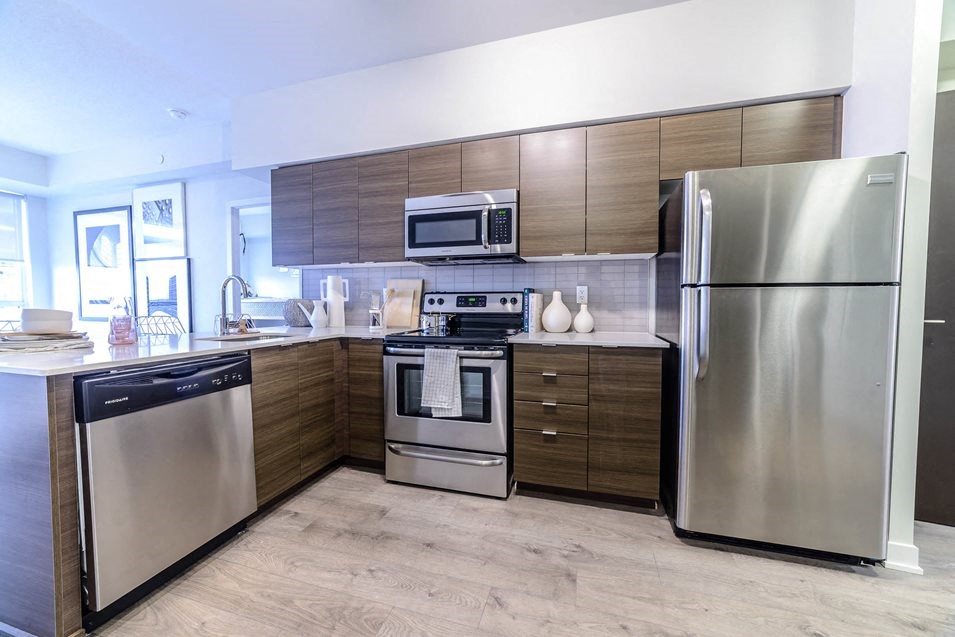 a kitchen with stainless steel appliances and wooden cabinets