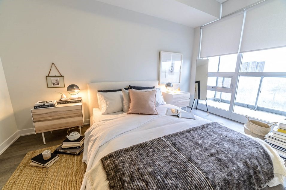 a bedroom with a bed and a large window