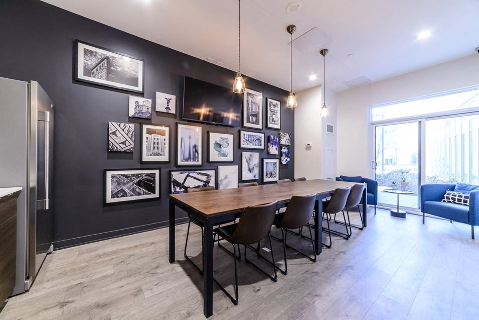 a dining room with a wooden table and chairs