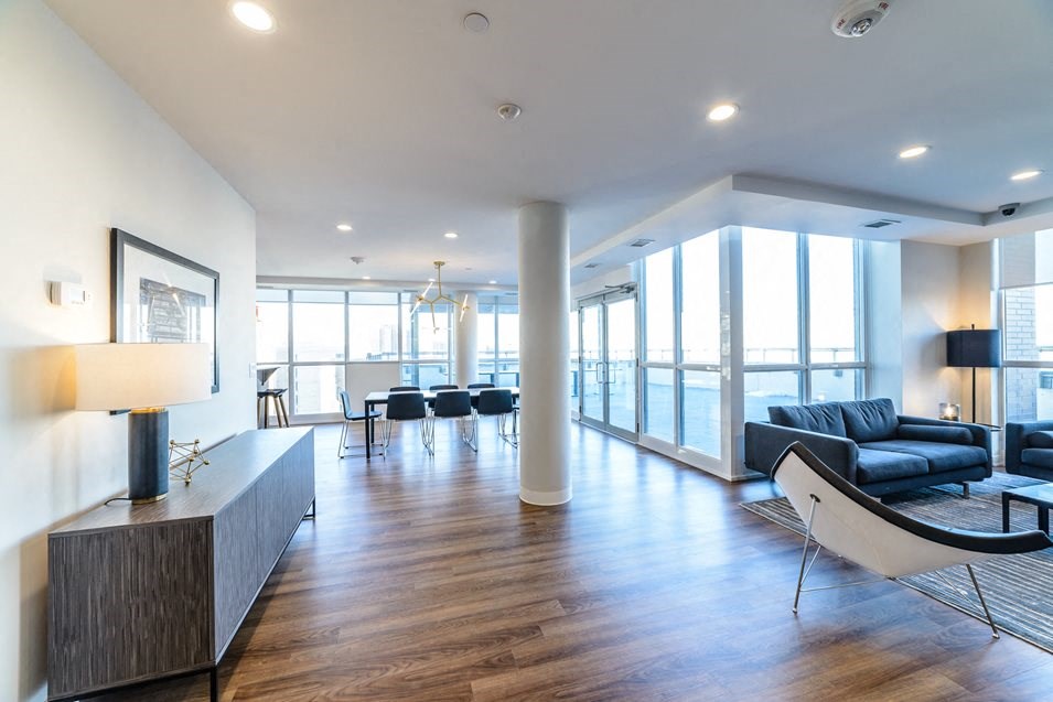 a living room with leather couches and a table and chairs
