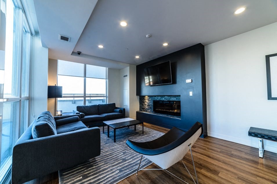 a living room with a couch and a chair and a fireplace