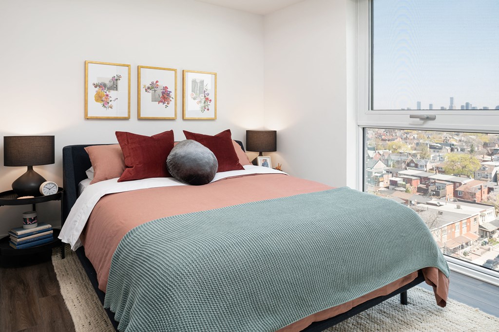 a bedroom with a bed and a large window