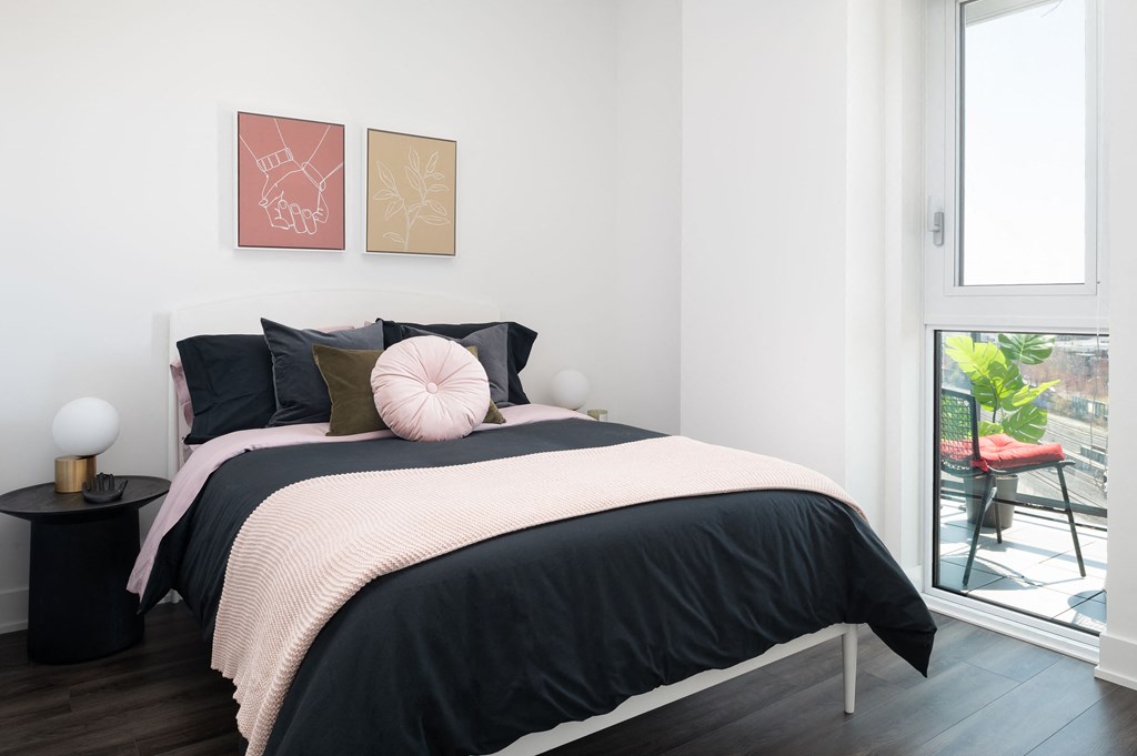 a bedroom with a bed and a large window