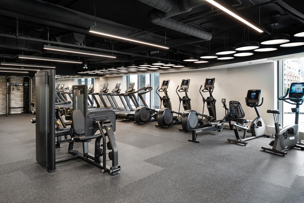 a group of exercise machines in a gym