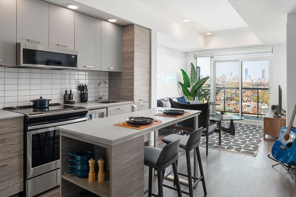 a kitchen with a large island and a table with chairs