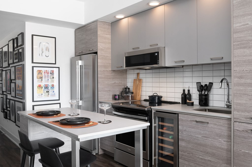 a kitchen with stainless steel appliances and a white table