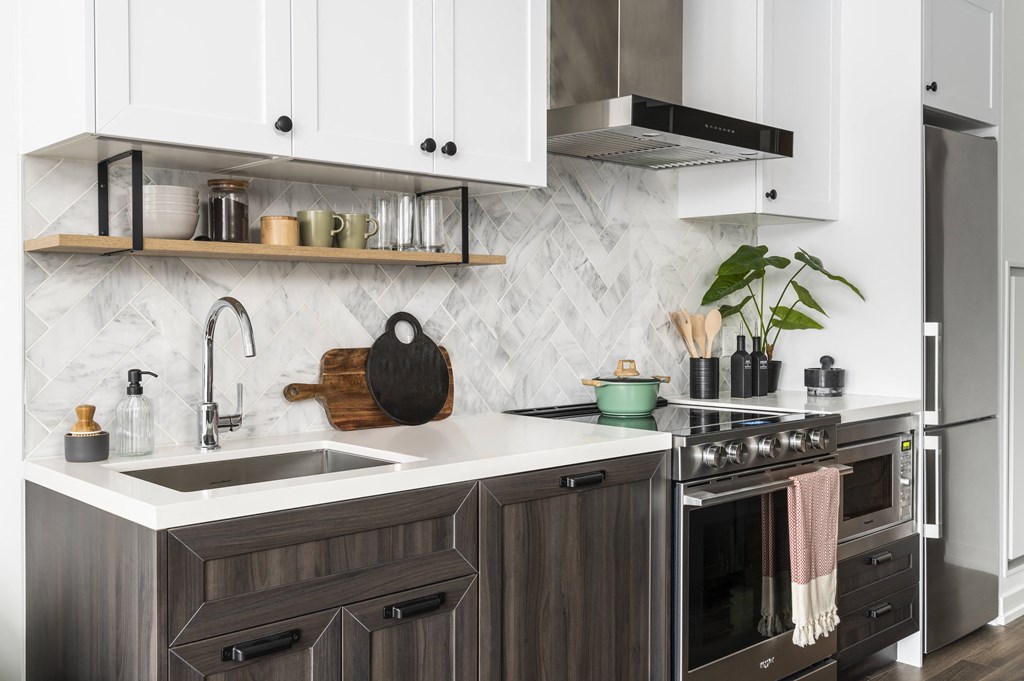 a kitchen with white cabinets and a sink and a stove