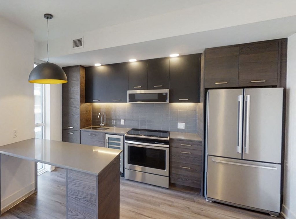 a kitchen with stainless steel appliances and wooden cabinets