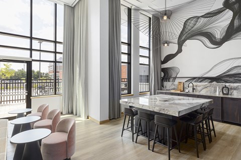 a kitchen with a marble table and chairs and a balcony