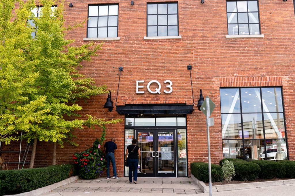 people standing in front of a brick building