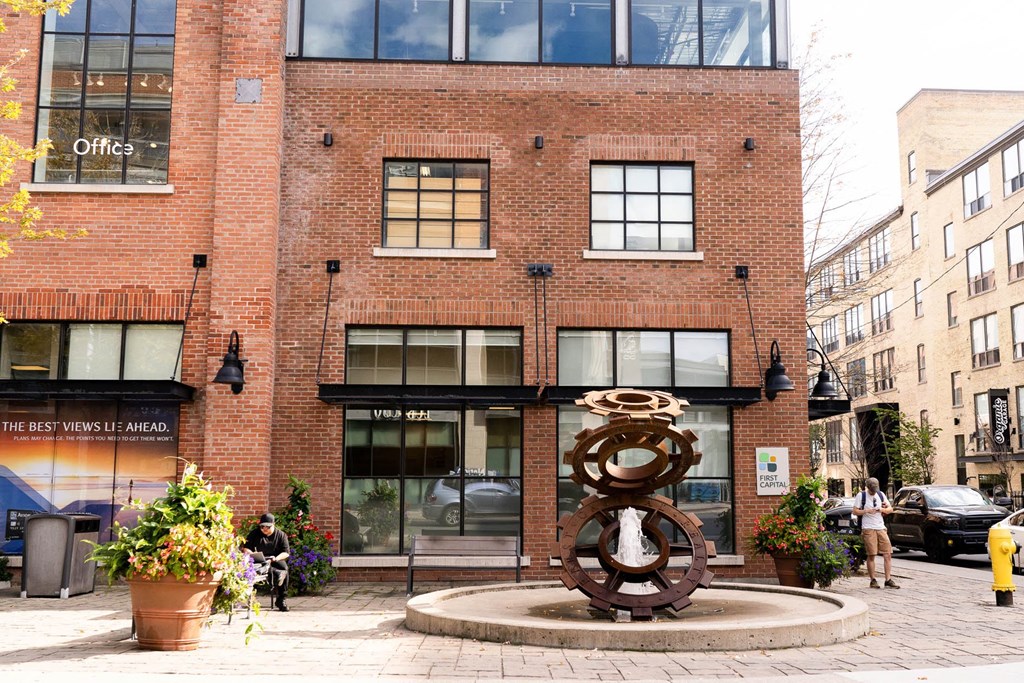 a sculpture in front of a brick building