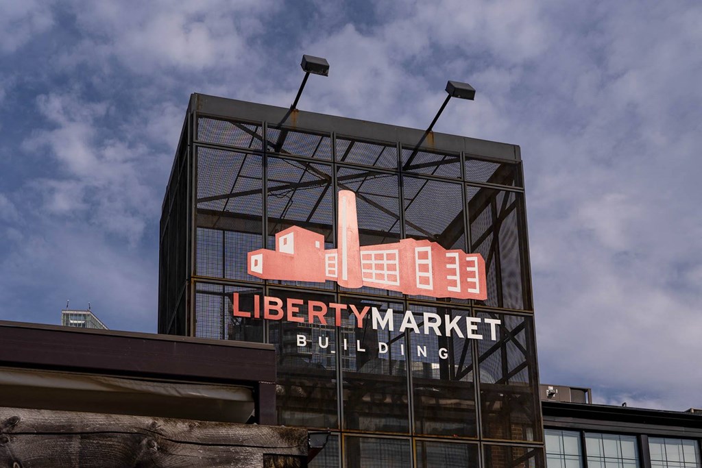 a sign for a building on the side of a building