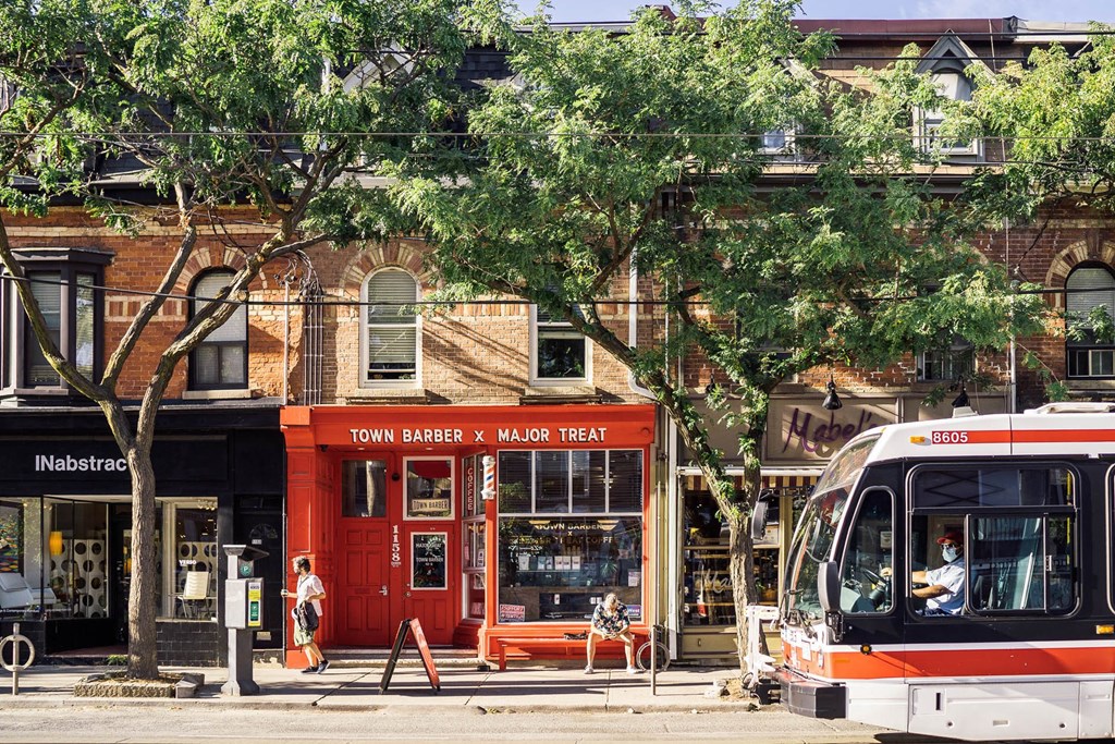 a city bus is parked in front of a red building