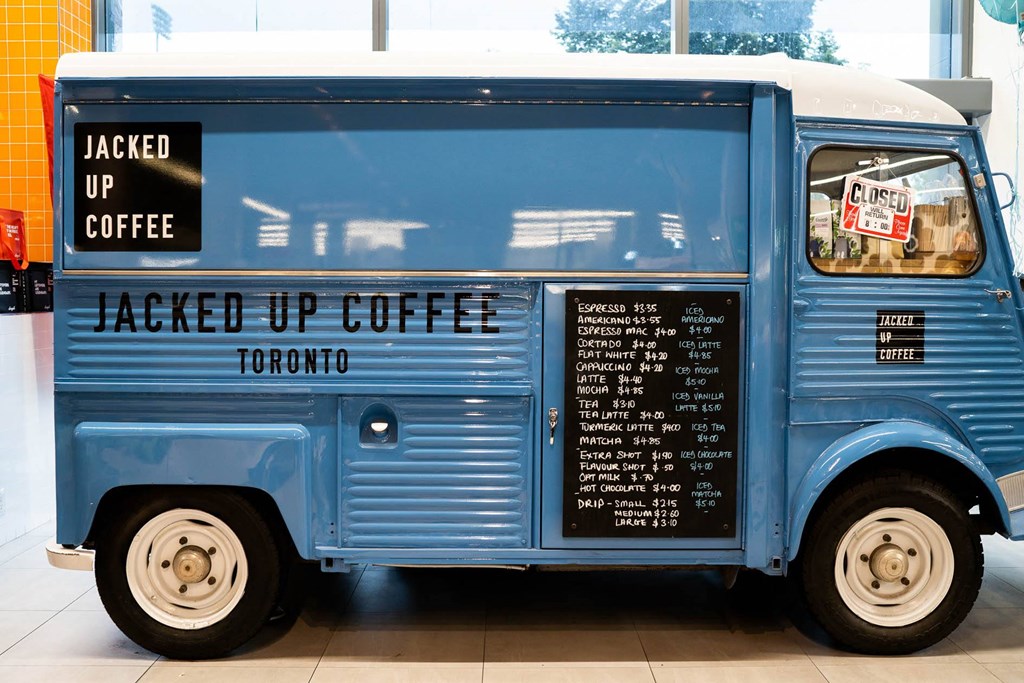 a blue truck with a menu on the side of it