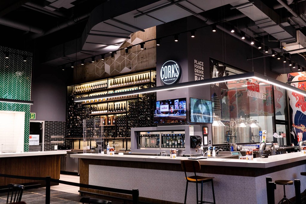 a bar in a restaurant with a liquor store and a large glass display case