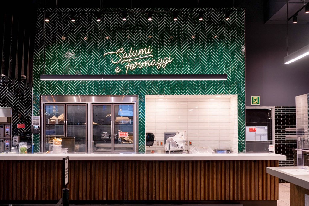 the counter of a restaurant with a green and white checkered wall