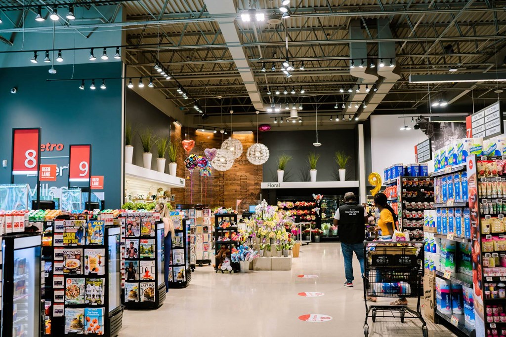 a grocery store with a lot of products and people in it