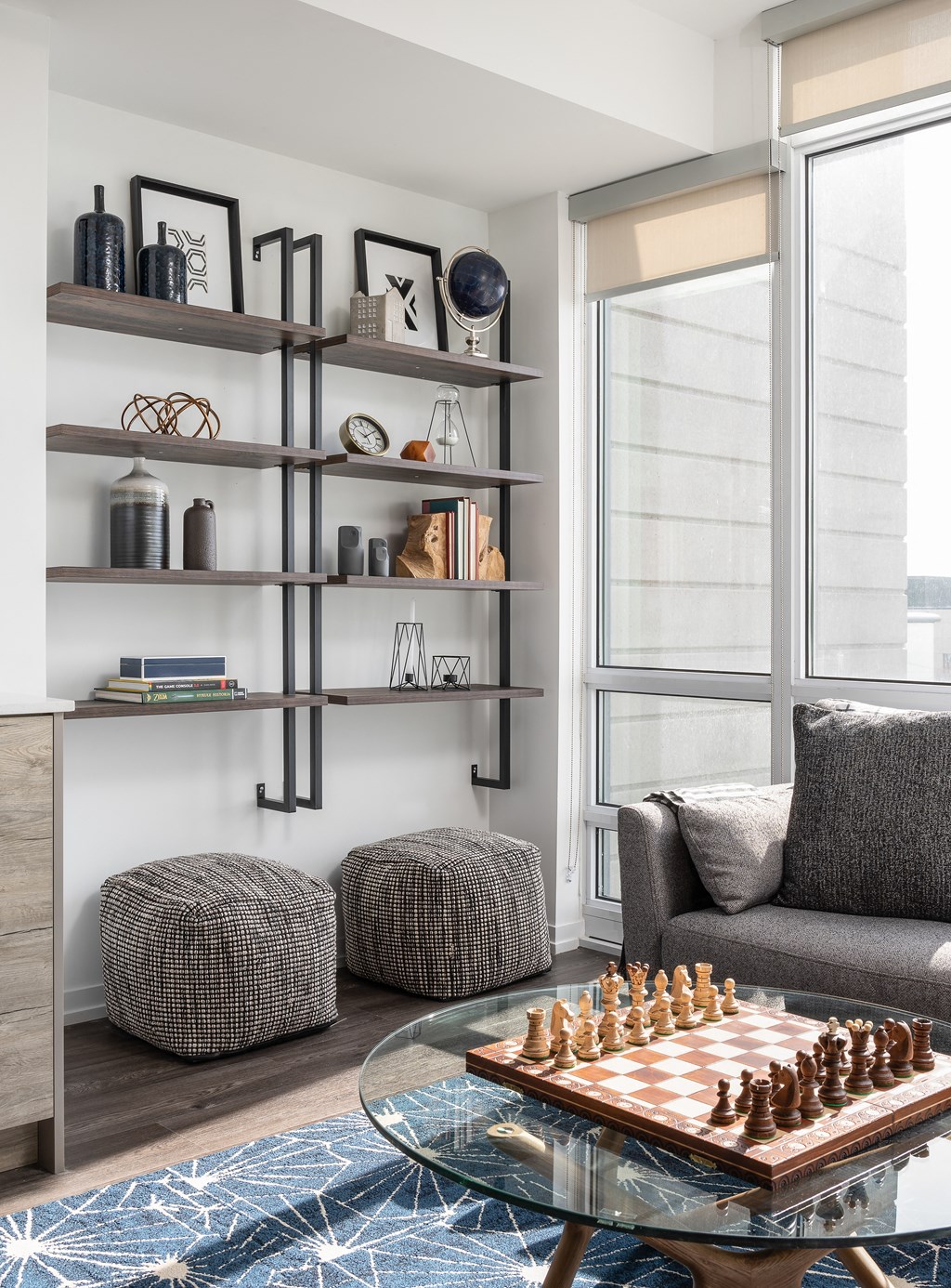 a living room with a couch and a table with a chess board