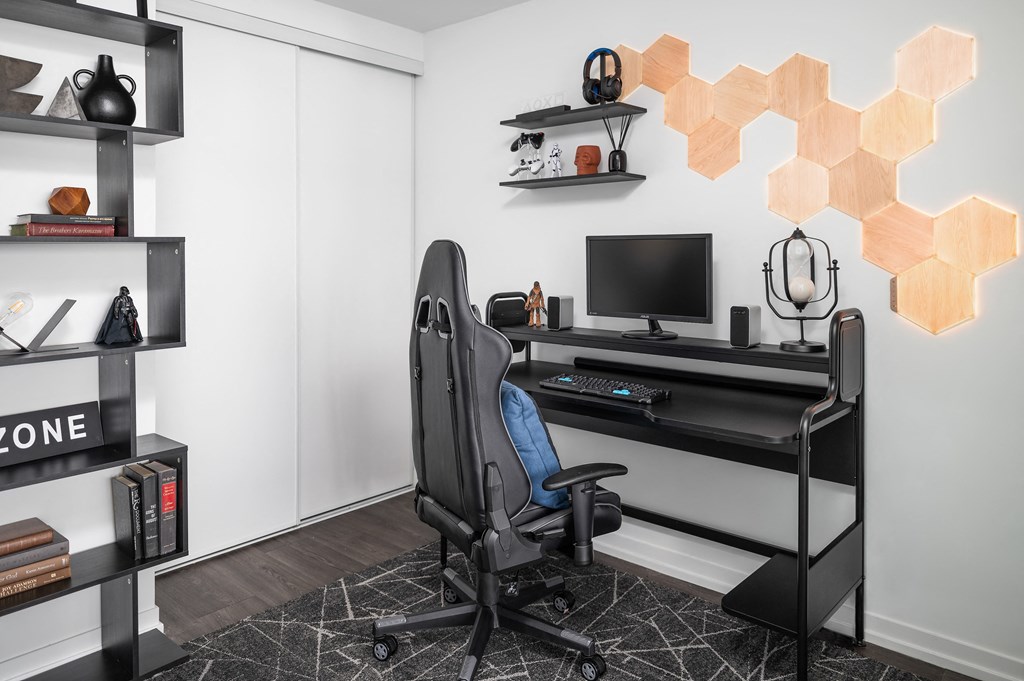 a home office with a computer desk and a chair