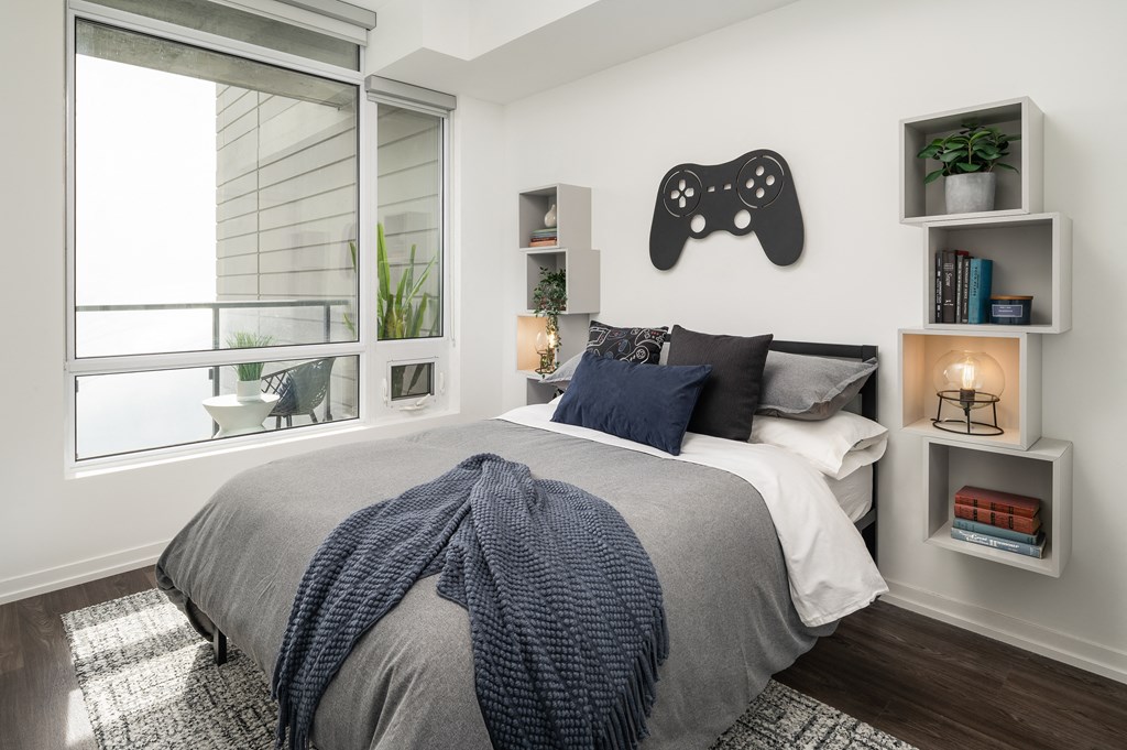 a bedroom with a large bed and a large window