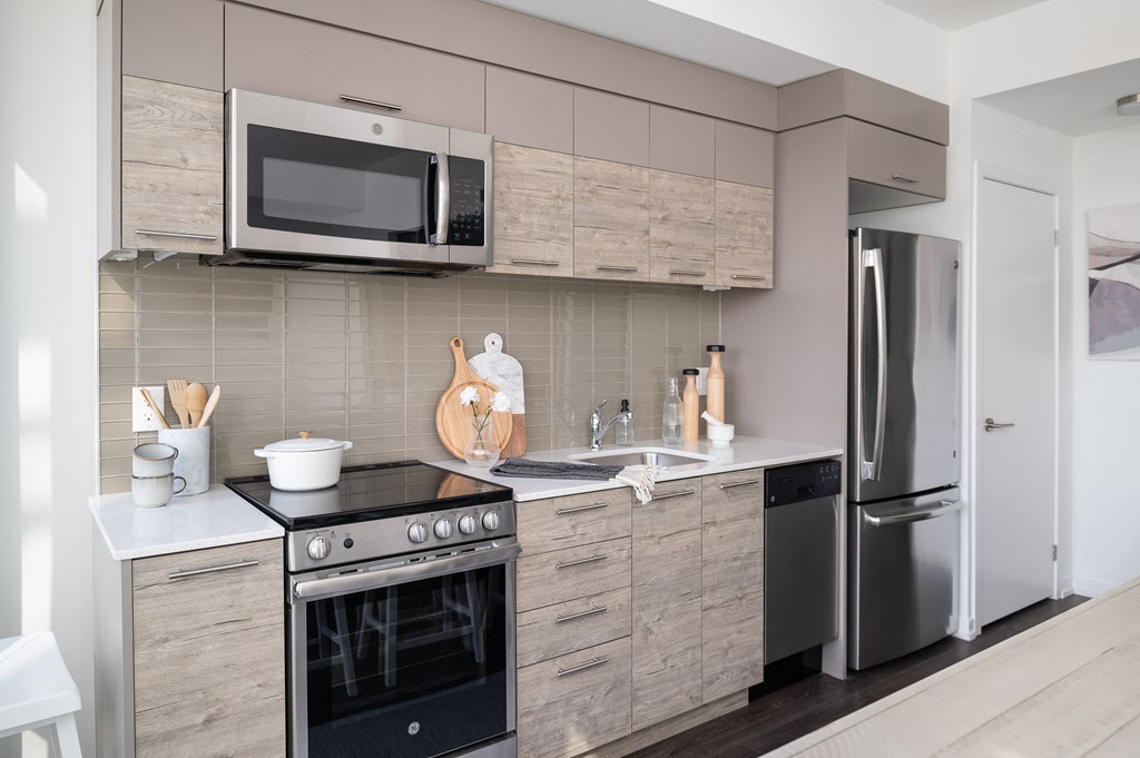 a kitchen with stainless steel appliances and wooden cabinets