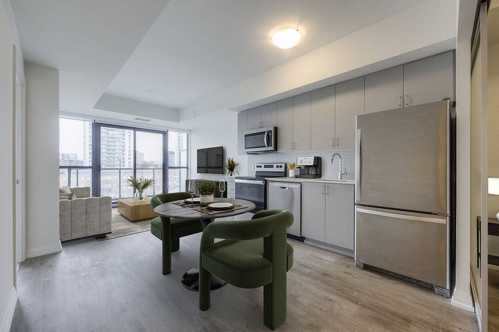 a kitchen and living room with a table and chairs