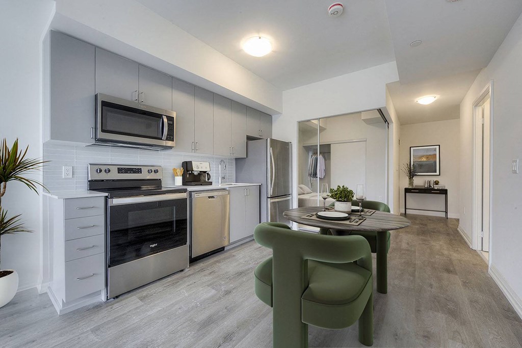 a kitchen with stainless steel appliances and a table