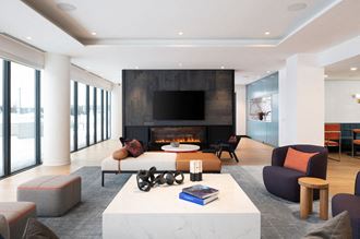 the living room has a fireplace and a large tv above it