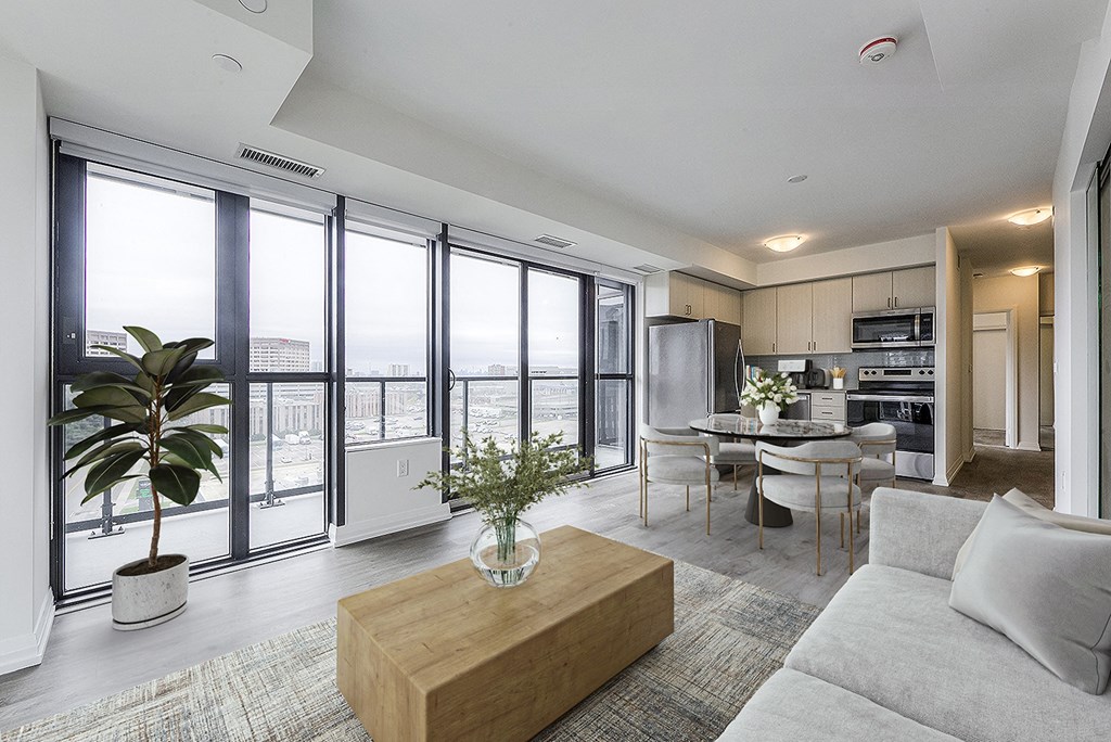 a living room with a view of a kitchen and a dining room