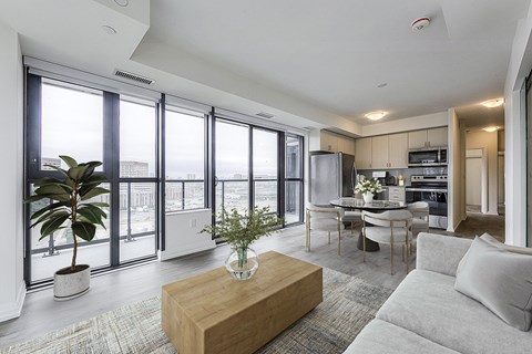 a living room with a view of a kitchen and a dining room