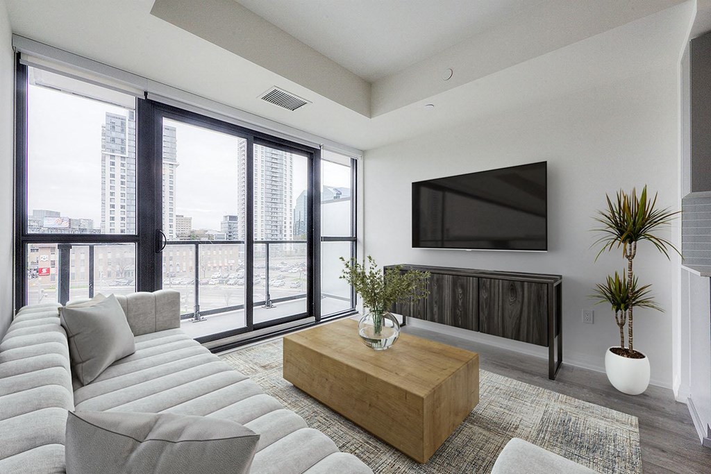 a living room with a white couch and a television