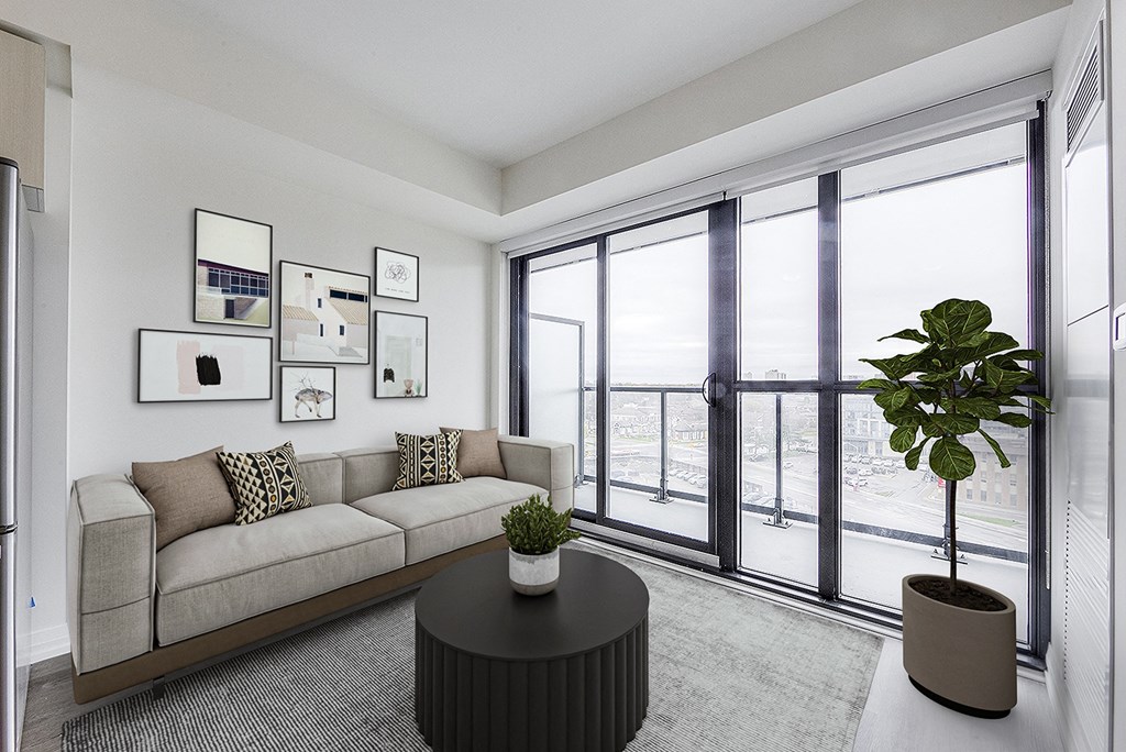 a living room with a couch and a table with a plant