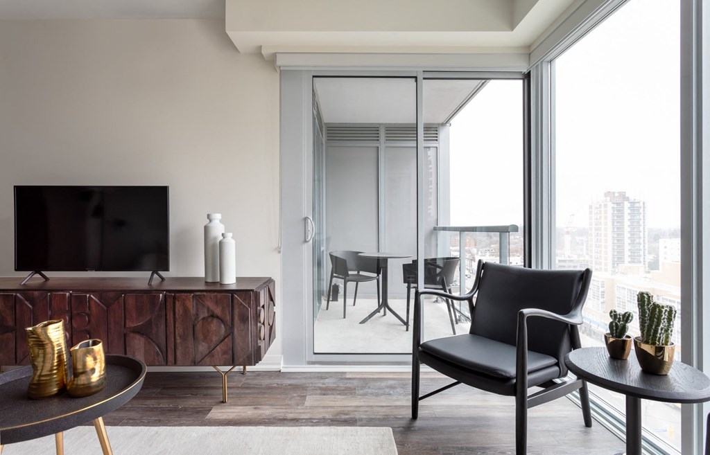 a living room with a tv and a balcony