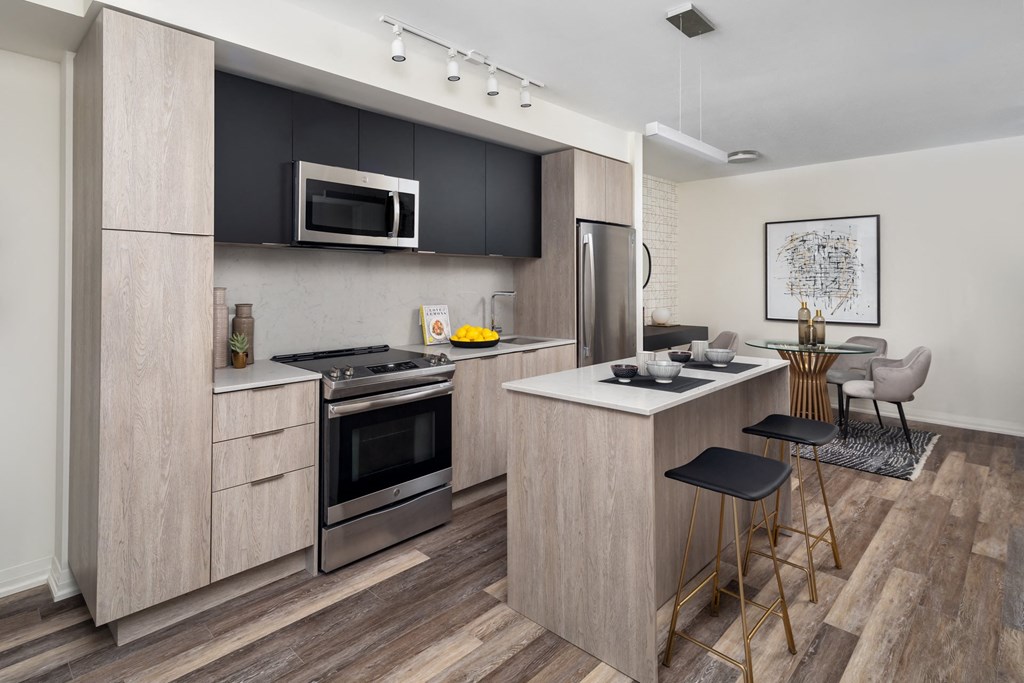 a kitchen with a center island and a stove and a microwave