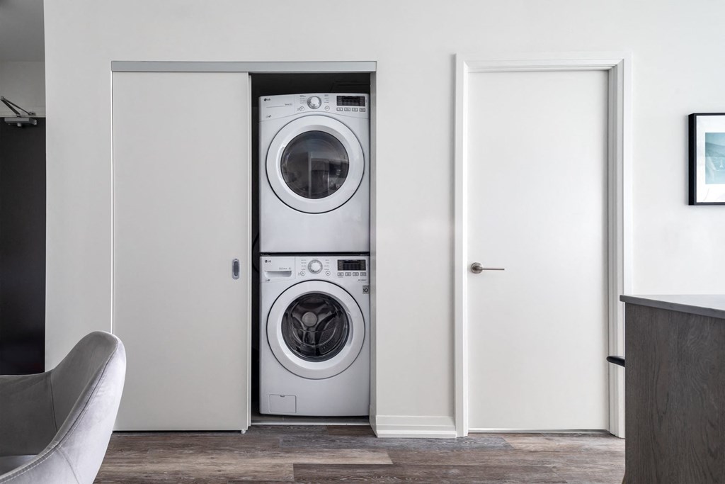 a white washer and dryer in a white closet