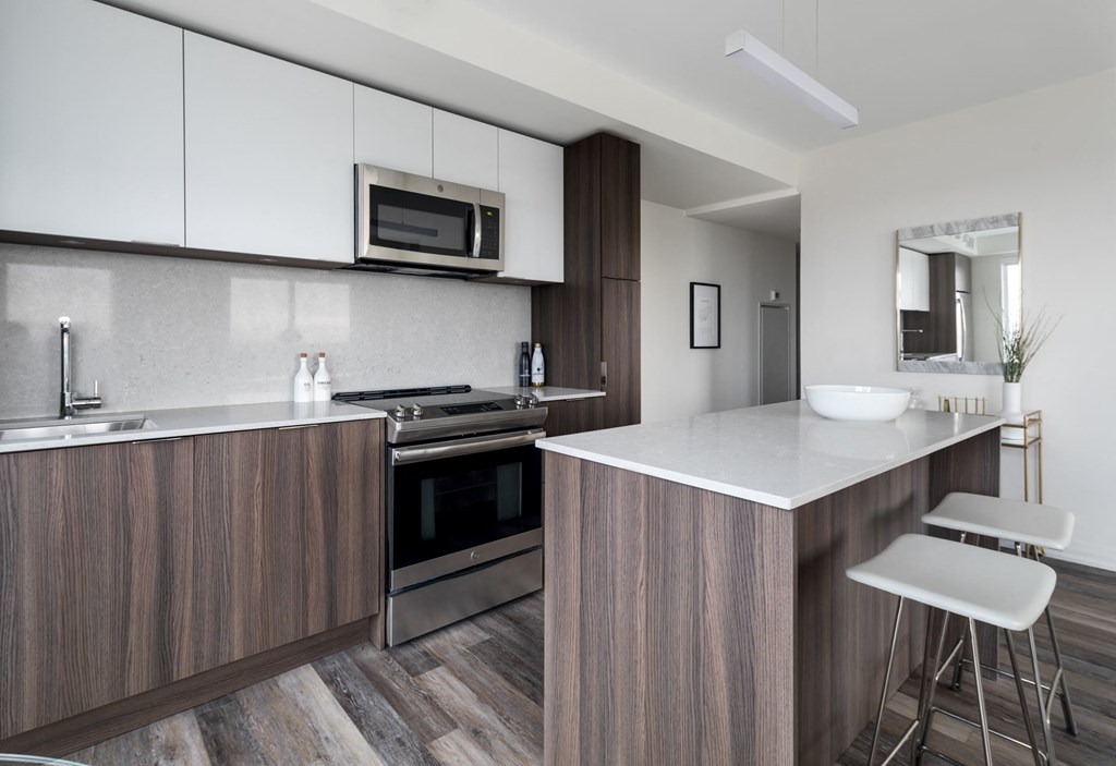 a kitchen with an island and a stove and a microwave