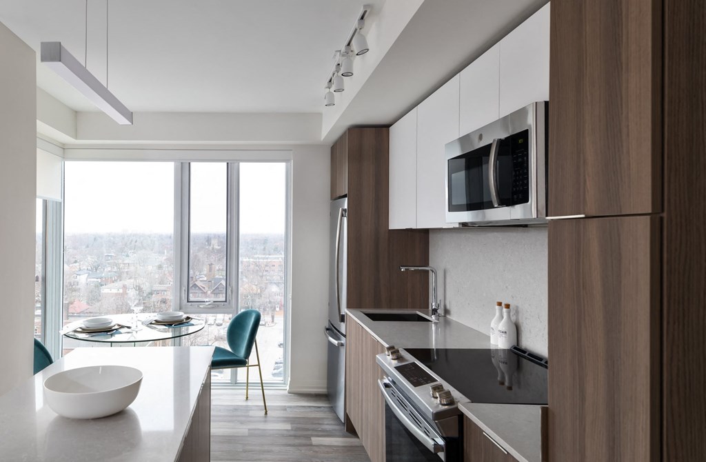 a kitchen with a counter top and a sink and a microwave