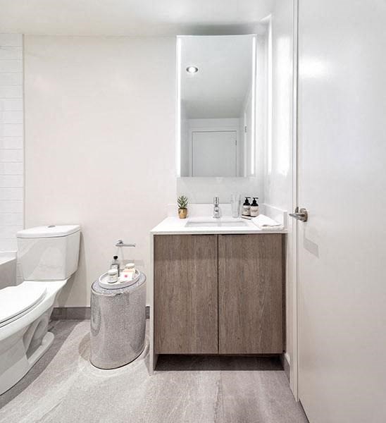 a bathroom with a toilet sink and a mirror