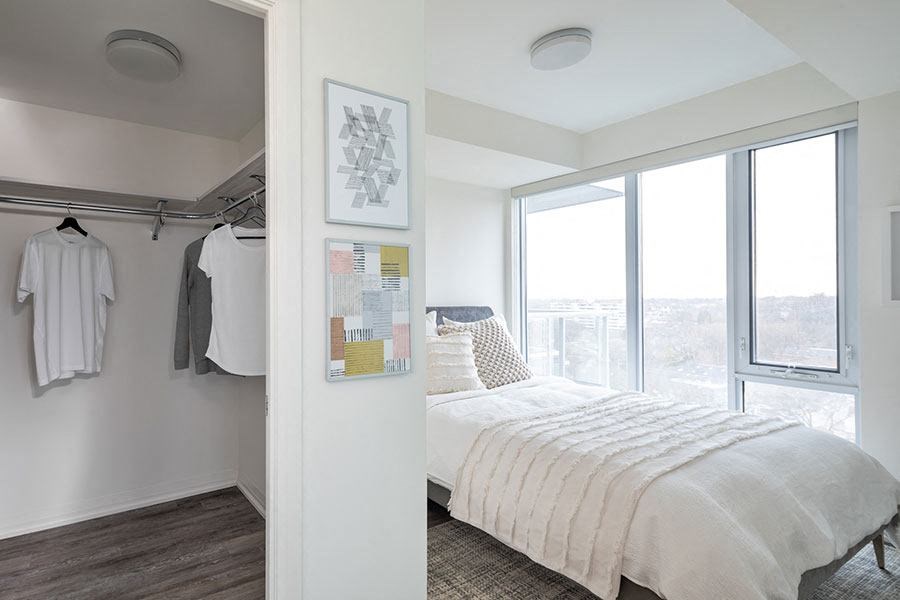 a bedroom with a bed and a large window