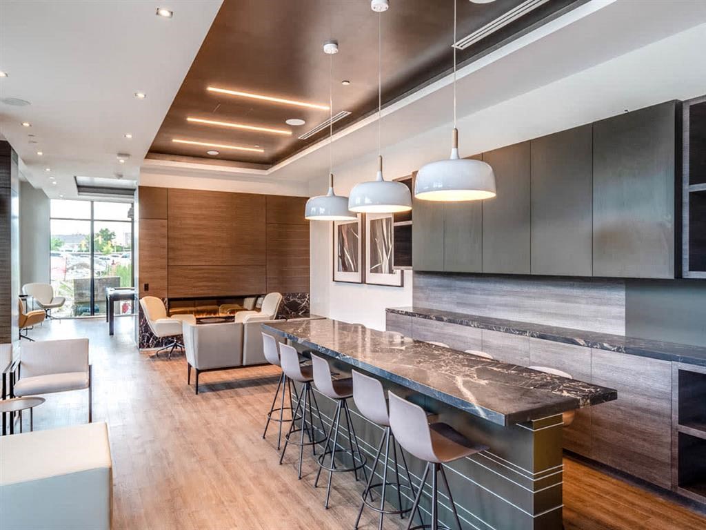 a large kitchen with a long counter and chairs