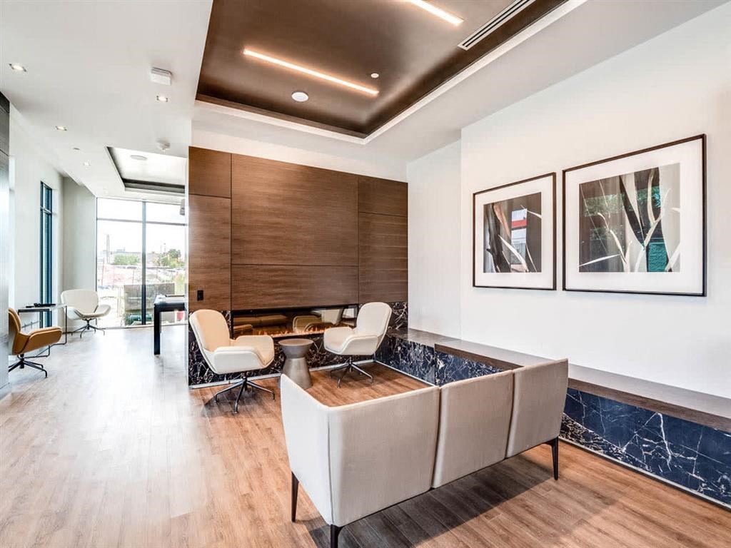 a living room with a couch and chairs and a table