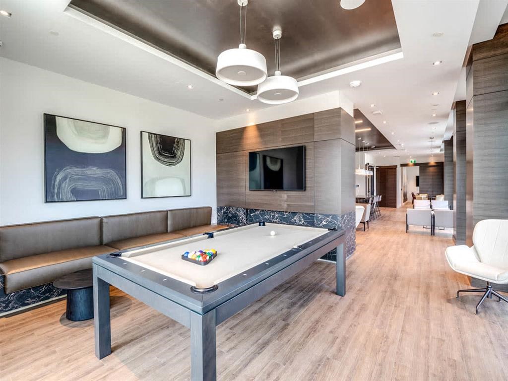 a game room with a pool table and a television