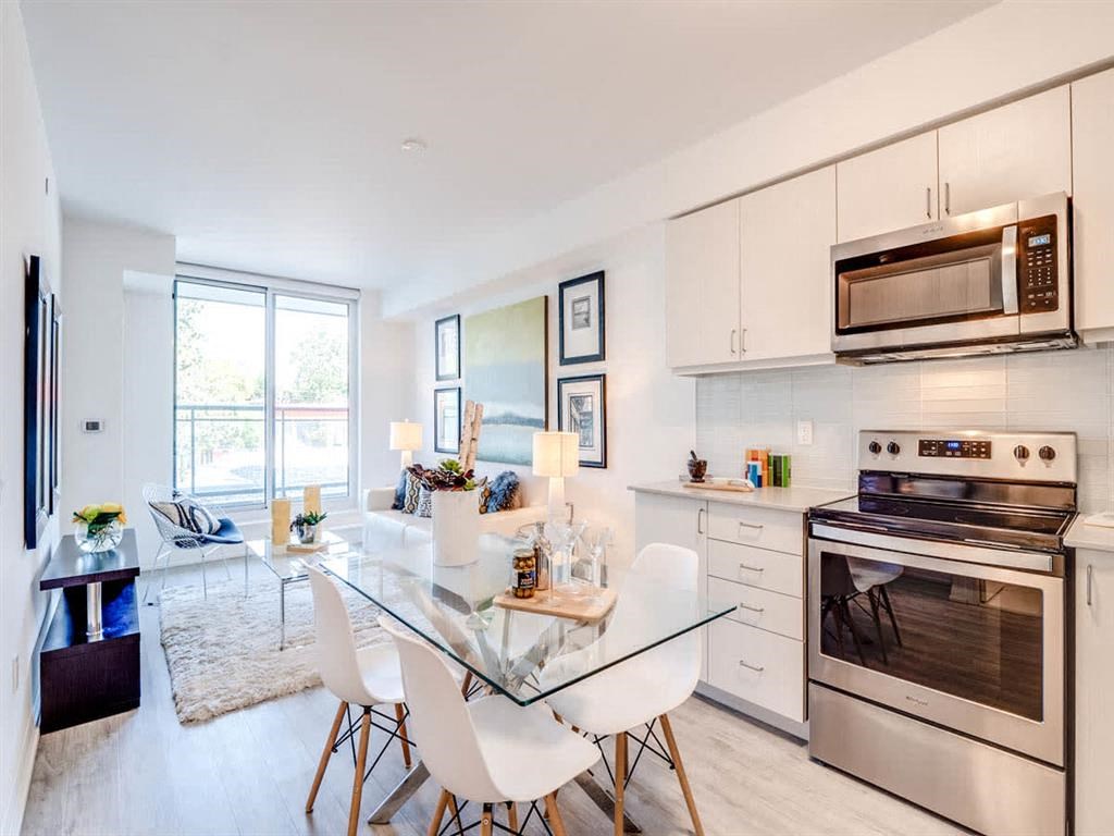 a kitchen with stainless steel appliances and a glass table
